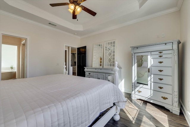 bedroom featuring hardwood / wood-style flooring, ceiling fan, ornamental molding, and a raised ceiling