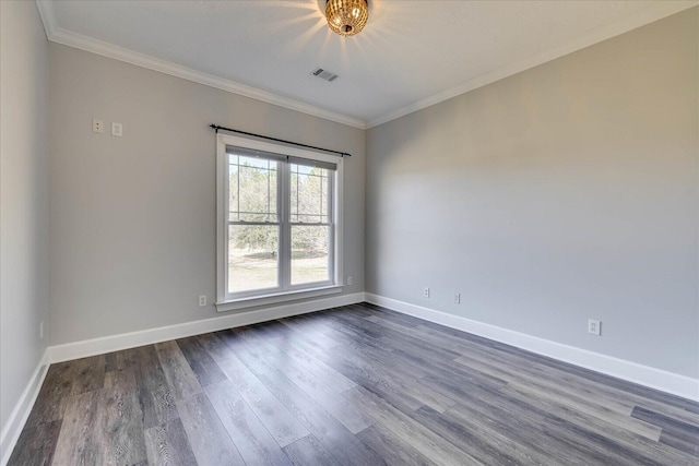 spare room with dark wood-type flooring and crown molding