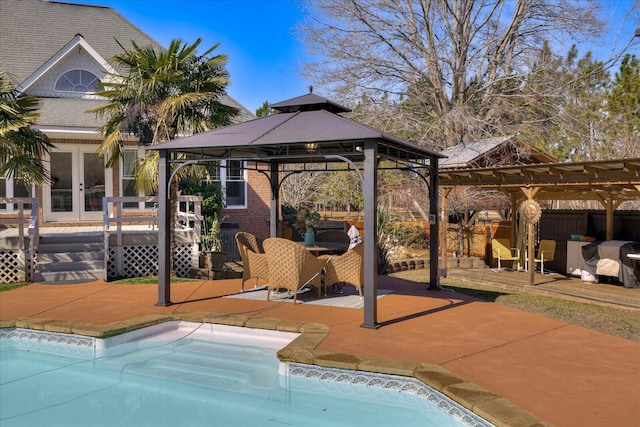 view of pool featuring a gazebo, a pergola, a patio area, and french doors