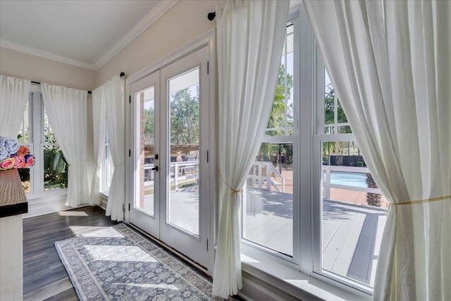 doorway to outside with ornamental molding, plenty of natural light, dark wood-type flooring, and french doors