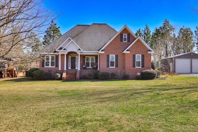 view of front of property with a garage, an outbuilding, and a front lawn