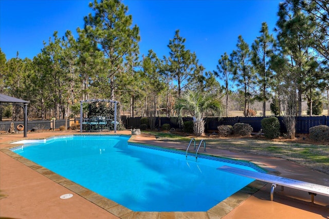 view of pool with a gazebo and a diving board