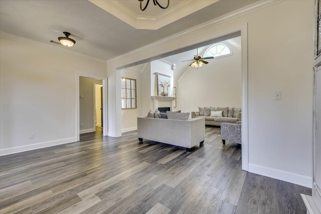 living room featuring ornamental molding, vaulted ceiling, dark wood-type flooring, and ceiling fan