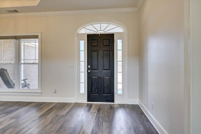 entryway featuring crown molding, dark wood-type flooring, and a healthy amount of sunlight