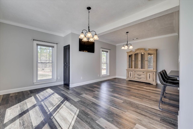 unfurnished dining area featuring an inviting chandelier, a healthy amount of sunlight, and dark hardwood / wood-style floors