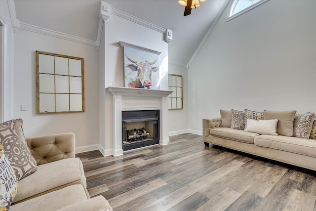 living room with crown molding, lofted ceiling, and hardwood / wood-style flooring