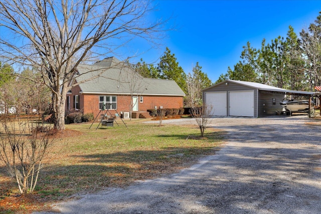 view of front facade with an outbuilding, a garage, and a front lawn