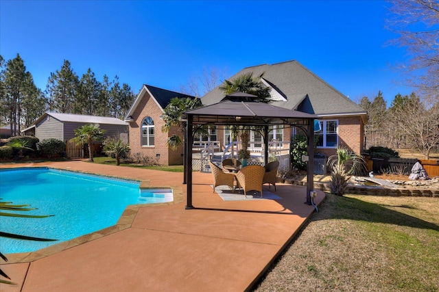 view of pool featuring a gazebo, a storage shed, and a patio