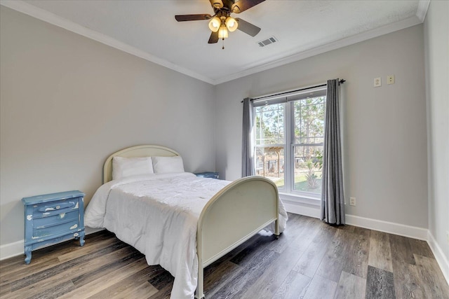 bedroom with crown molding, ceiling fan, and dark hardwood / wood-style flooring