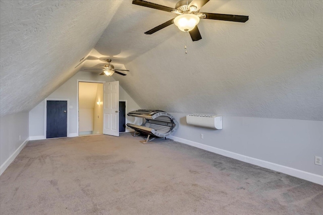 bonus room featuring vaulted ceiling, carpet, and a textured ceiling