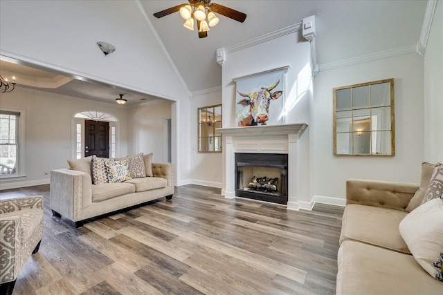 living room featuring crown molding, hardwood / wood-style floors, and high vaulted ceiling