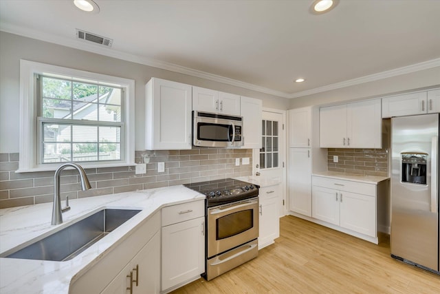 4142 Quinn Dr, Evans, GA 30809 - kitchen featuring appliances with stainless steel finishes, white cabinets, decorative backsplash, recessed lighting, and light stone counters