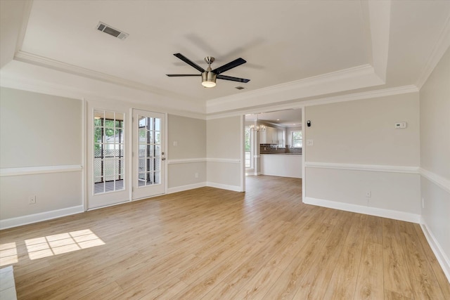 4142 Quinn Dr, Evans, GA 30809 - spare room featuring a tray ceiling, ceiling fan, light wood finished floors, ornamental molding, and a chandelier