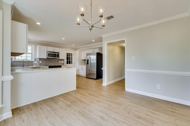 4142 Quinn Dr, Evans, GA 30809 - kitchen featuring appliances with stainless steel finishes, ornamental molding, decorative backsplash, light countertops, and light wood-type flooring
