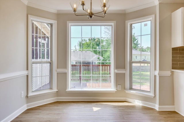 4142 Quinn Dr, Evans, GA 30809 - unfurnished dining area featuring a chandelier, plenty of natural light, crown molding, and wood finished floors