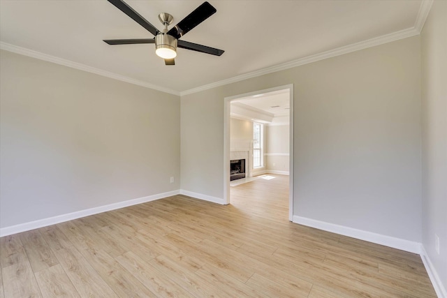 4142 Quinn Dr, Evans, GA 30809 - spare room featuring ornamental molding, a ceiling fan, light wood-type flooring, and a fireplace with flush hearth