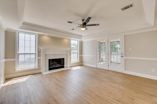 4142 Quinn Dr, Evans, GA 30809 - unfurnished living room featuring a raised ceiling, crown molding, ceiling fan, and plenty of natural light