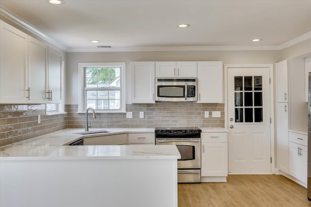 4142 Quinn Dr, Evans, GA 30809 - kitchen with appliances with stainless steel finishes, white cabinetry, recessed lighting, and ornamental molding