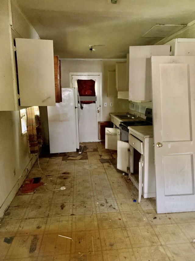 1555 Koger St, Augusta, GA 30904 - kitchen featuring freestanding refrigerator, light floors, electric range oven, and light countertops
