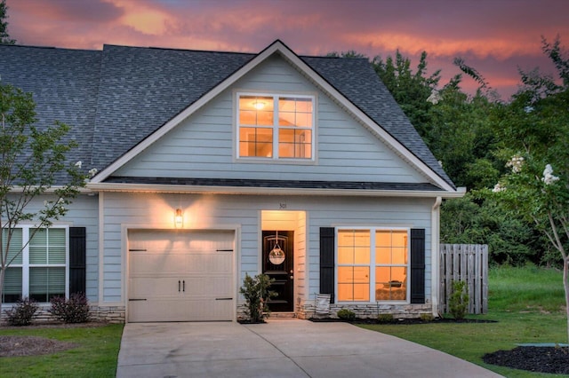 view of front of property with a yard and a garage