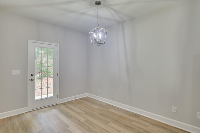 2815 Ridge Crest Dr, Hephzibah, GA 30815 - unfurnished dining area featuring light wood-type flooring, a chandelier, and baseboards