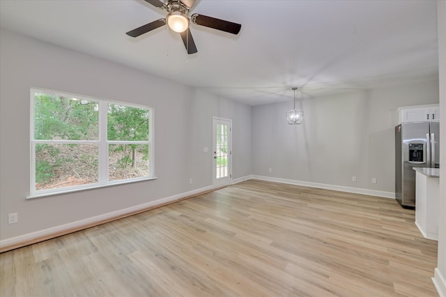 2815 Ridge Crest Dr, Hephzibah, GA 30815 - unfurnished living room with light wood finished floors, baseboards, and a ceiling fan