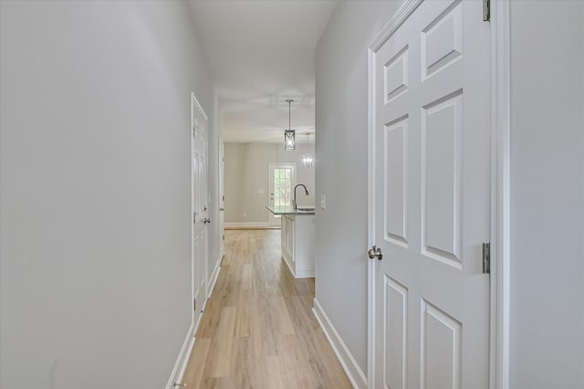 2815 Ridge Crest Dr, Hephzibah, GA 30815 - hallway with light wood finished floors, a sink, and baseboards