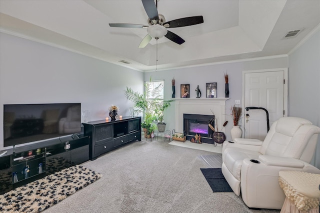 2211 Altman Way, Hephzibah, GA 30815 - living room with carpet, a tray ceiling, ceiling fan, a fireplace with flush hearth, and crown molding