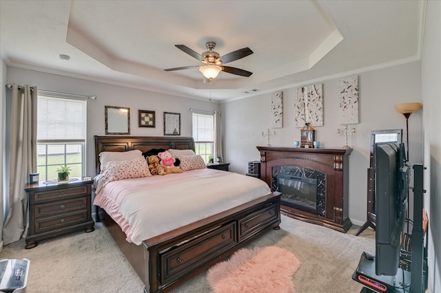 2211 Altman Way, Hephzibah, GA 30815 - bedroom with a tray ceiling, light carpet, a glass covered fireplace, crown molding, and a ceiling fan