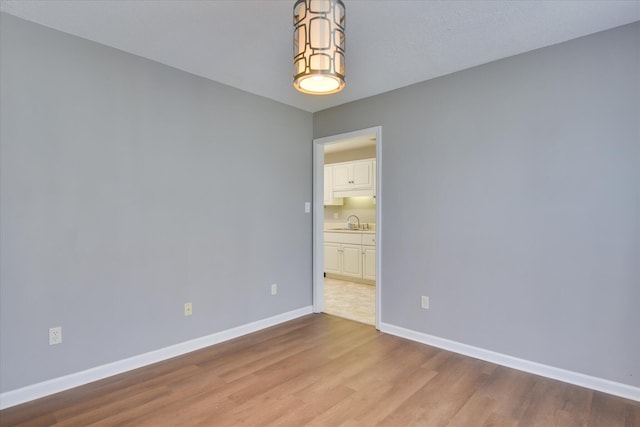 3643 Stanton Ct, Augusta, GA 30906 - empty room with wood finished floors, baseboards, and a sink
