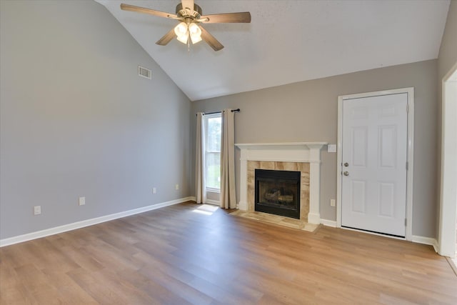 3643 Stanton Ct, Augusta, GA 30906 - unfurnished living room featuring ceiling fan, light wood finished floors, a tile fireplace, high vaulted ceiling, and baseboards