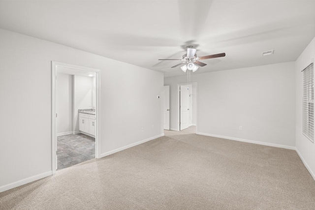 carpeted empty room with ceiling fan