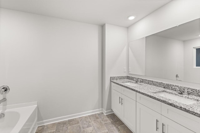 bathroom with vanity and a tub to relax in