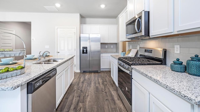 kitchen with white cabinetry, stainless steel appliances, sink, and tasteful backsplash