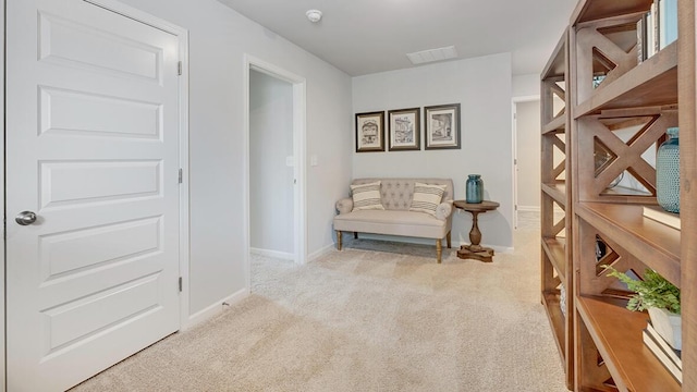 sitting room featuring light carpet