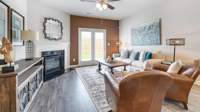 living room with ceiling fan and wood-type flooring