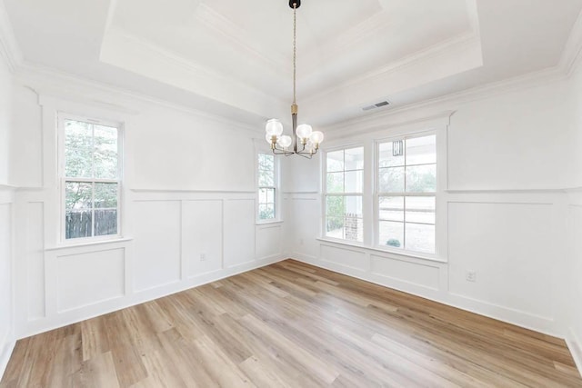141 NE Union St, Aiken, SC 29801 - empty room featuring a decorative wall, a chandelier, light wood finished floors, a tray ceiling, and ornamental molding