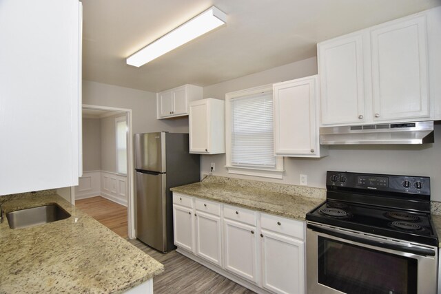 2320 Henry Cir, Augusta, GA 30906 - kitchen featuring under cabinet range hood, appliances with stainless steel finishes, a sink, white cabinets, and light wood-style floors
