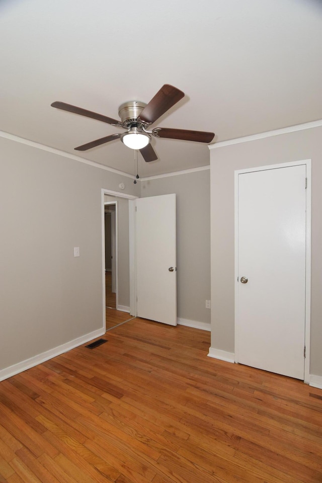 2320 Henry Cir, Augusta, GA 30906 - empty room with crown molding, a ceiling fan, light wood-style flooring, and baseboards