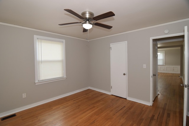 2320 Henry Cir, Augusta, GA 30906 - unfurnished bedroom with ornamental molding, wood finished floors, baseboards, and ceiling fan