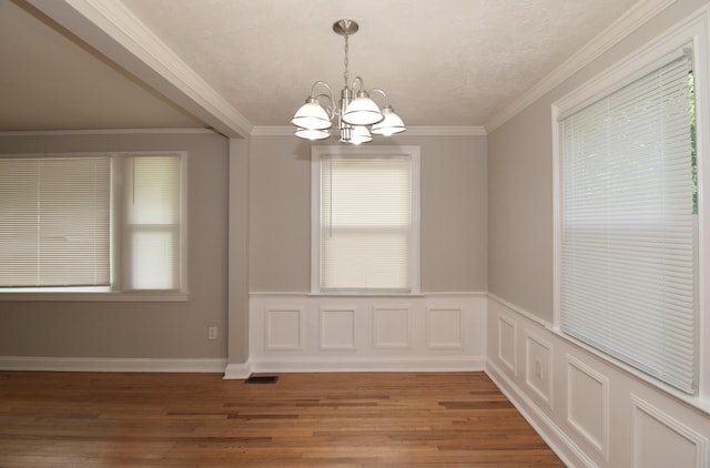 2320 Henry Cir, Augusta, GA 30906 - empty room with a chandelier, wood finished floors, plenty of natural light, ornamental molding, and wainscoting