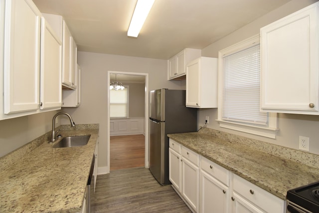 2320 Henry Cir, Augusta, GA 30906 - kitchen with a sink, dark wood-type flooring, white cabinets, appliances with stainless steel finishes, and a chandelier