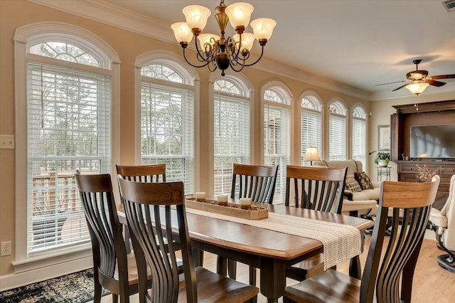 dining area with crown molding and ceiling fan with notable chandelier