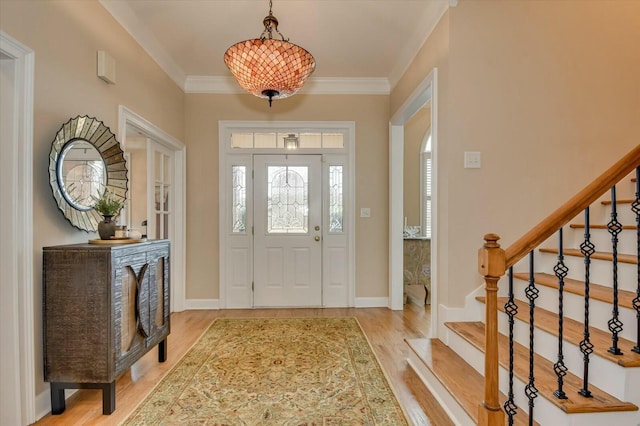 entrance foyer featuring wood-type flooring and crown molding