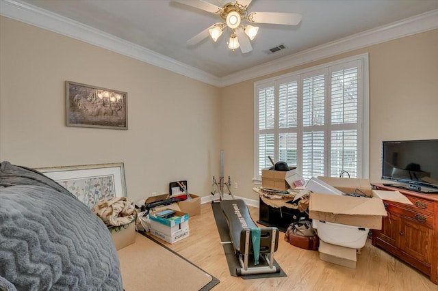 bedroom with light wood-type flooring, ceiling fan, crown molding, and multiple windows