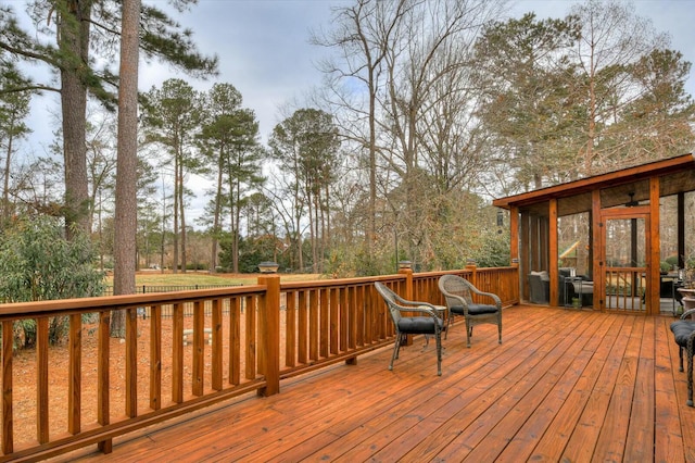 wooden deck featuring a sunroom