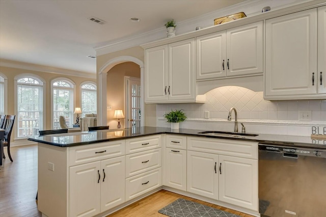 kitchen with sink, black dishwasher, white cabinets, and kitchen peninsula