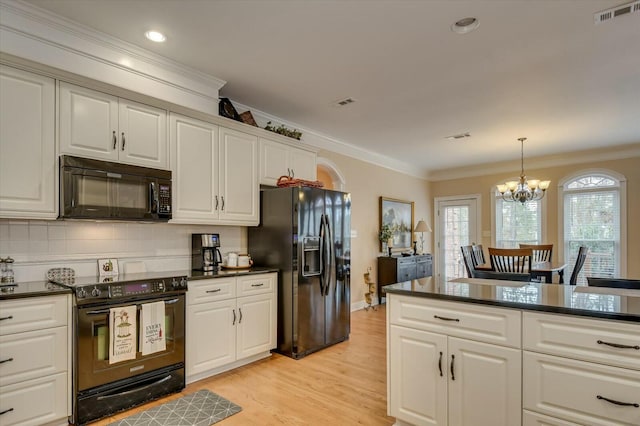 kitchen with decorative light fixtures, black appliances, tasteful backsplash, an inviting chandelier, and crown molding