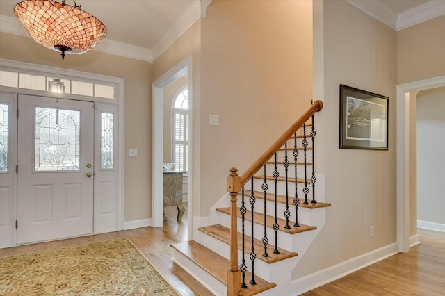 entryway featuring light hardwood / wood-style floors and crown molding