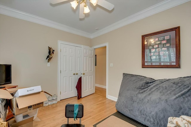 interior space with hardwood / wood-style flooring, ceiling fan, and ornamental molding